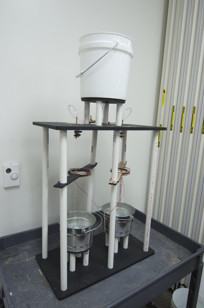 An electrostatic machine I made that generates several thousand volts with no moving parts other than two drizzling nozzles issuing a stream of water droplets under the pull of gravity.